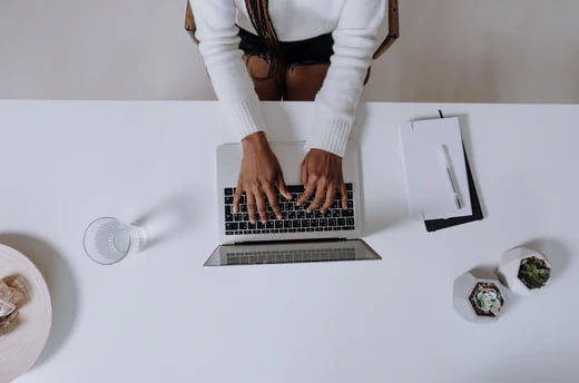 A person sitting at a desk with a laptop
